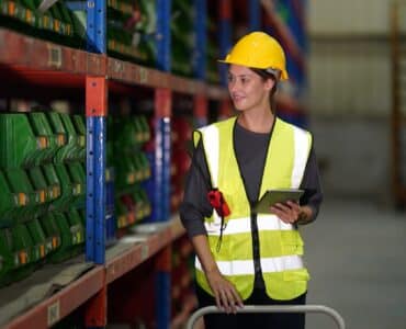 Warehouse Industrial supply chain and Logistics Companies inside. Warehouse workers checking the inv